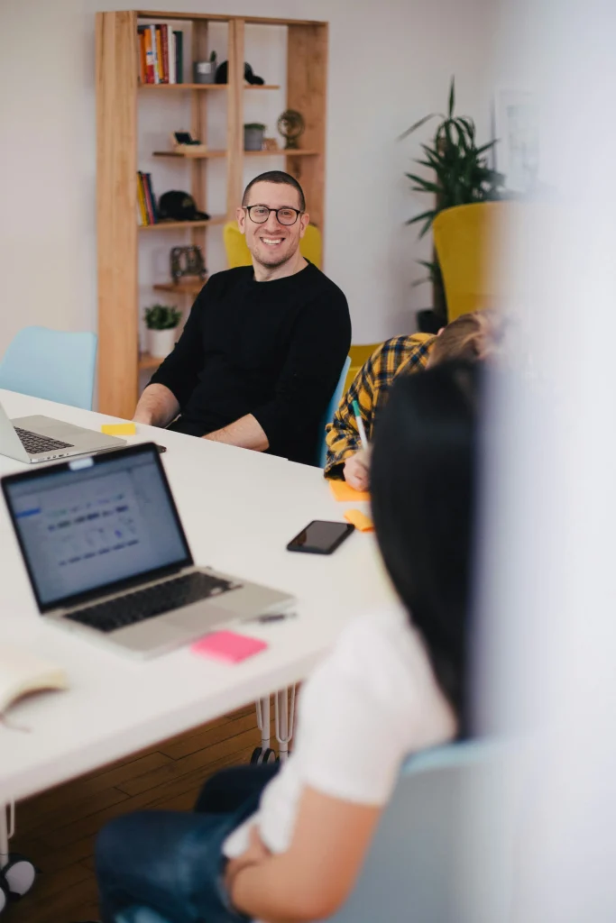 homme souriant à côté d'une femme qui écrit